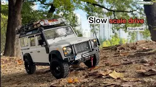 1/10 Scale RC Drive I Land Rover Defender driving at low speed up a small hill