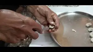 How to break cashew nut shell  manually using traditional instrument