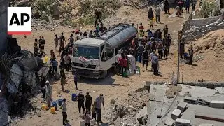Gaza City residents wait for water at the truck after famine declare