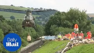 Military helicopter drops off supplies at Toddbrook Reservoir