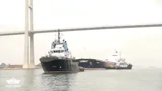 Egyptian authorities tow refloating cargo vessel grounded in Suez Canal | AFP