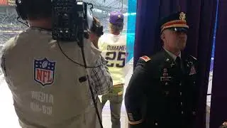 Josh Duhamel blowing the horn at the Vikings game on Christmas Day.