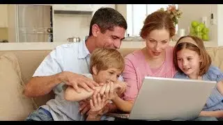 Happy Family Sitting on the Sofa Using Laptop Together | Stock Footage - Videohive