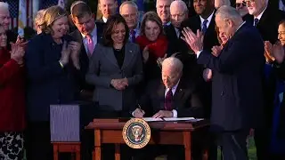 Biden signs infrastructure bill into law at rare bipartisan gathering