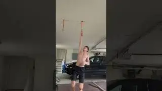 One arm pull up on vertical rock climbing hold