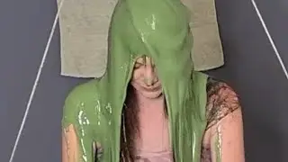 gorgeous girl Nickelodeon green slimed / gunged in a beautiful formal ballgown dress in a gungetank
