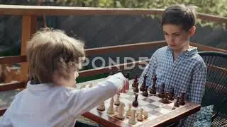 Preschool Children Learning Play Smart Board Game Chess. Boy Moves Pawn Piece Video
