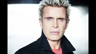 67 Year old grandad & ex punk Billy Idol rocking a red sofa to promote his 