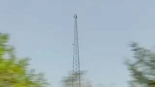 A cell tower with a small cell antenna rack