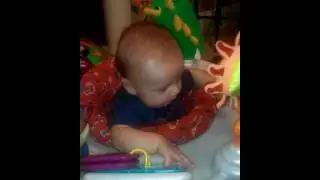Adam figuring out his hands at 12 weeks.