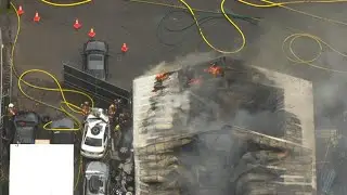 Crews battle two-alarm fire at auto wrecking shop in Gresham