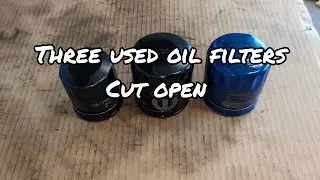 Three random used oil filters cut open to see there wonders