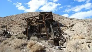 Abandoned car and an old Mill in the desert
