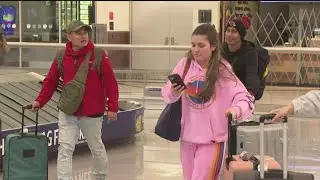People at Atlanta airport deal with travel woes due to winter weather