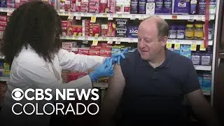 Gov. Jared Polis gets COVID-19 and flu shots at local pharmacy