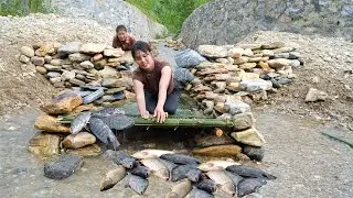 Single girl and her friend create a unique fish trap using rocks, a natural way to catch fish