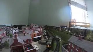 N gauge class 24 hauling rake of maroon Gresley coaches.