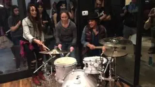 Emmanuelle Caplette, Kimberly Thompson, Val Sepulveda playing on one drum set