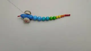 PlanToys Pull Along Snake, a colorful wooden toy designed for young kids
