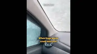 Huge waves crash onto car driving along the beachside road
