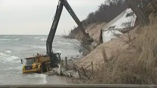 Cottage removed piece-by-piece after collapsing onto a Lake Michigan beach