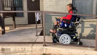 Haji Mada, 9, receives a electric wheelchair