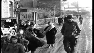 Refugee women on road carry children, bedding and luggage in Rahier, Belgium. HD Stock Footage