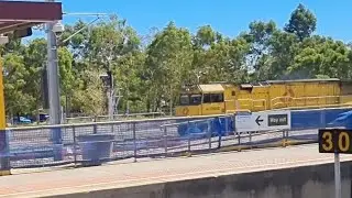 Aurizon freight trains pass at Old midland Station 