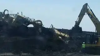 Big Heavy equipment fail. 627 scraper falls off stockpile