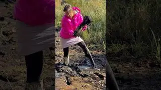 Hard stuck in deep mud messy beautiful Girl in Hunter wellies and shiny nylon rain jacket