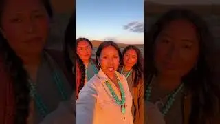 The central woman speaks calmly and clearly, maintaining direct eye contact with the camera