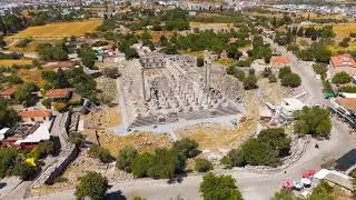 Didim, Turkey. Drone flight from Apollo Temple entrance to general view showing Didim town, field...