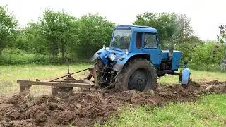 The tractor is plowing the land