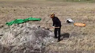 Backfilling a soil testing pit by hand- Middle of August 2025