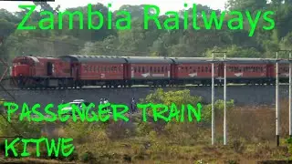 Zambia Railways passenger train leaves Kitwe. Black Mountain scene.