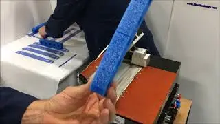 Hot Melt Rollcoater applying precise coating of pressure sensitive hot melt to strips of foam