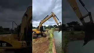 A Powerful Excavator in Action Along the Canal, Demonstrating Strength, Precision, and Hard Word.