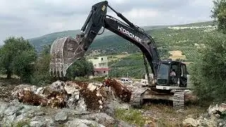 Arazi de taş sökümü, taş duvar, yol açma Hidromek 300-Stone removal on rocky terrain, stone wall.