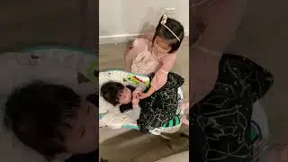 Big sister taking care of little brother to have a pacifier