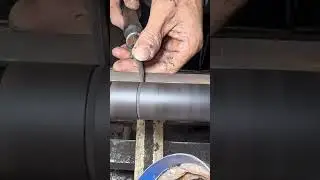 Wood turning on a lathe shaping a smooth cylinder with precise chisel control
