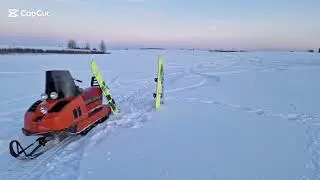 Snowboarding behind a snowmobile Buran 