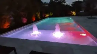 sundeck swimming  pool bubblers at night