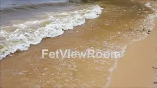 Sea wave on the sand of the beach close-up