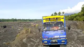 Sand-Laden Trucks Traverse Dangerous Routes