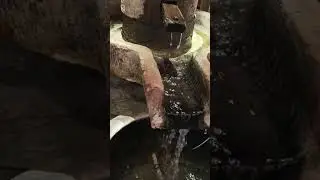 This is the shape of an old grinder made of stone which is now used as a water fountain #food