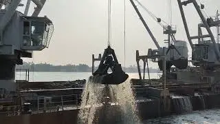 ship in port. ship maintanance. dredging. grab hopper dredger.