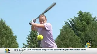Alice Thonnard, a French foreign exchange student, learns softball at Vinton-Shellsburg