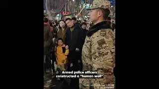 Armed police officers joined hands to create a 