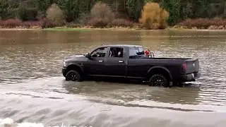 Drone video shows pickup driving through flooded Washington state road