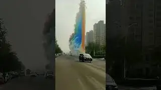 Giant rainbow smoke column appears on city street!